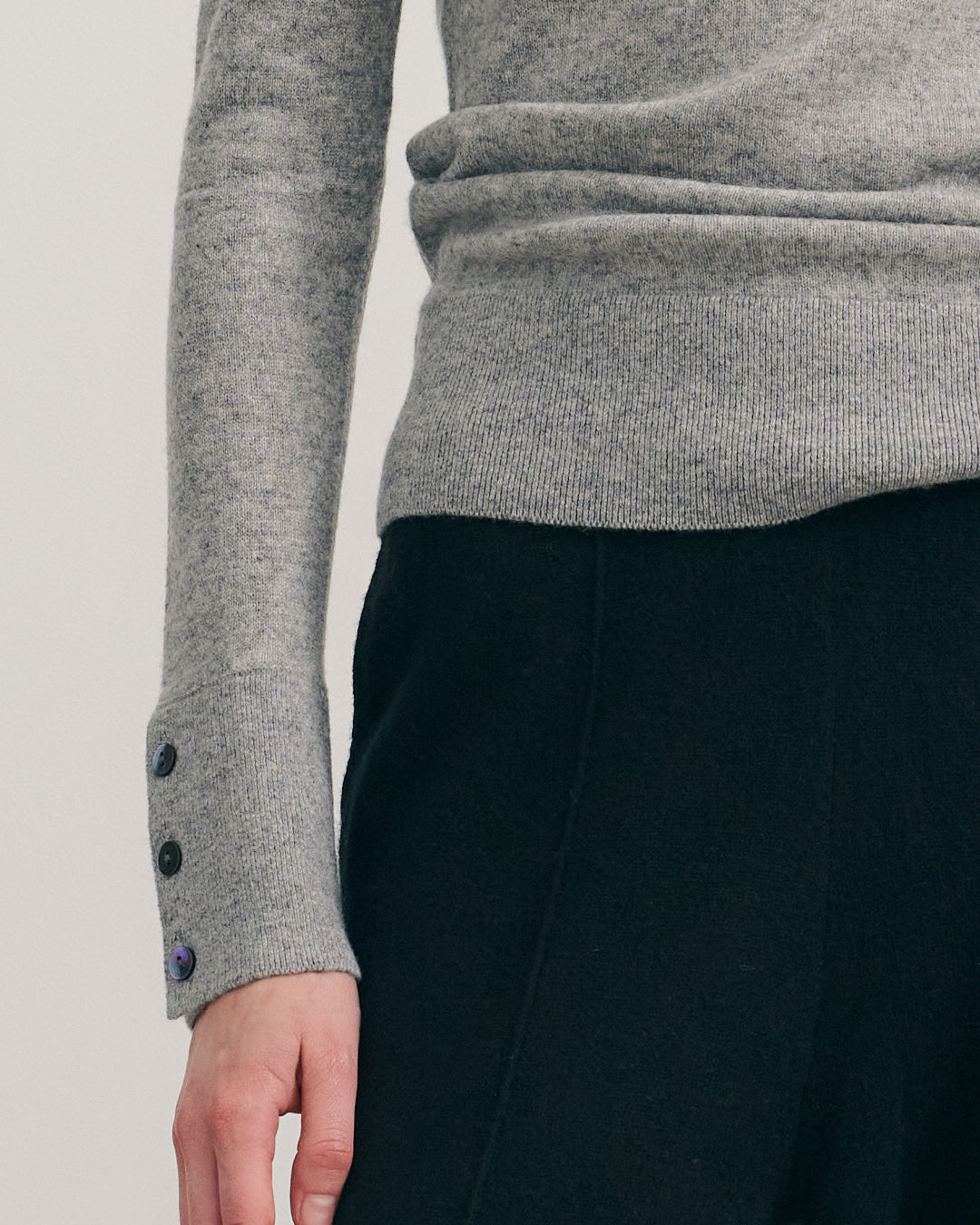 Detail shot of fine ribbed crew neckline on steel grey cashmere jumper