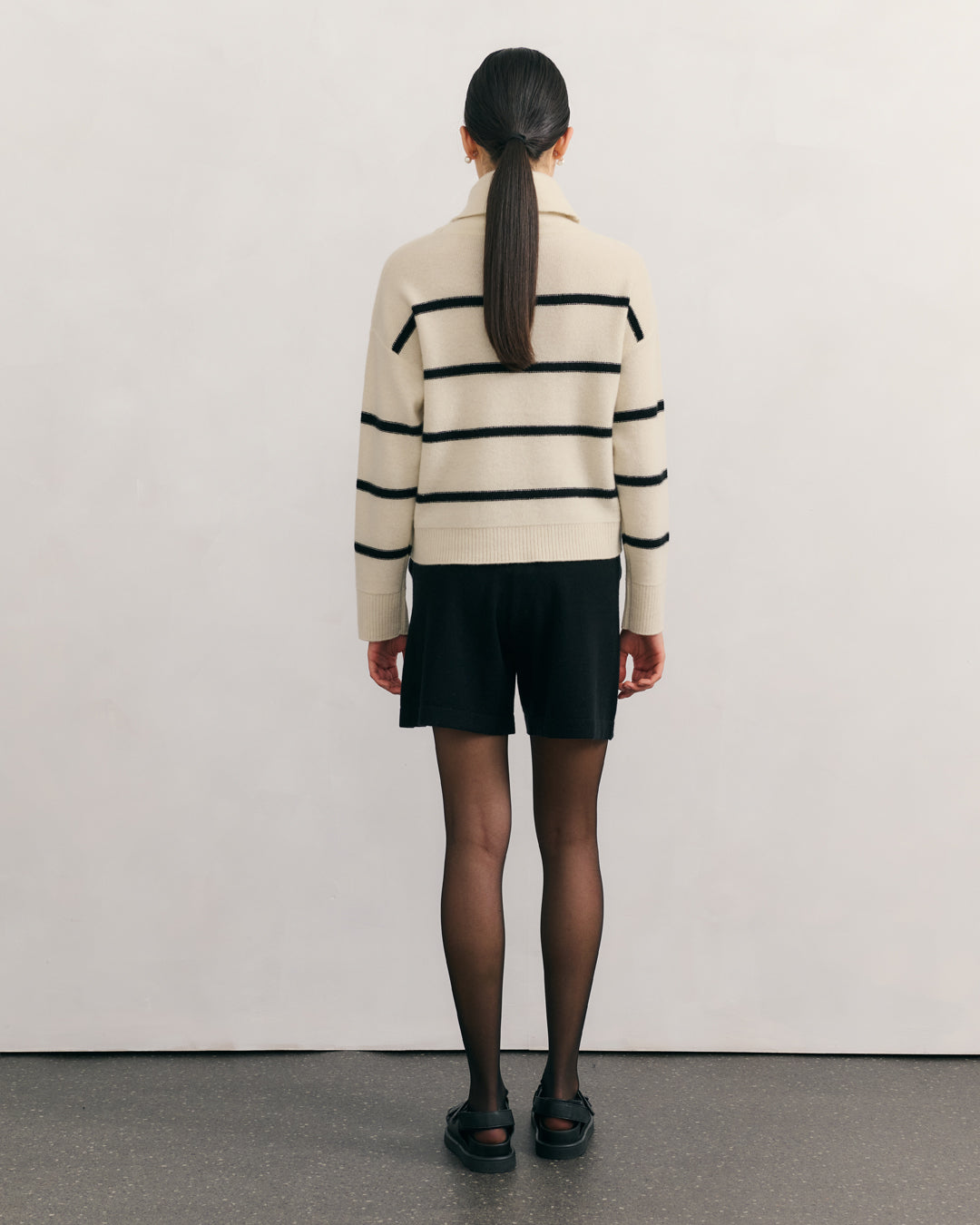 Back view of relaxed boxy striped cashmere sweater in cream and black