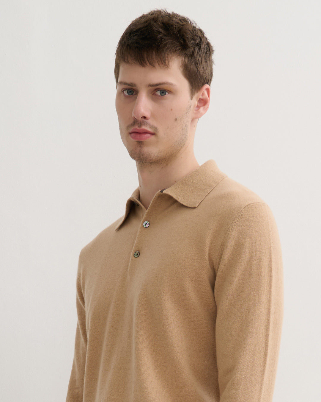 Model wearing cashmere polo style sweater in camel - collar detail