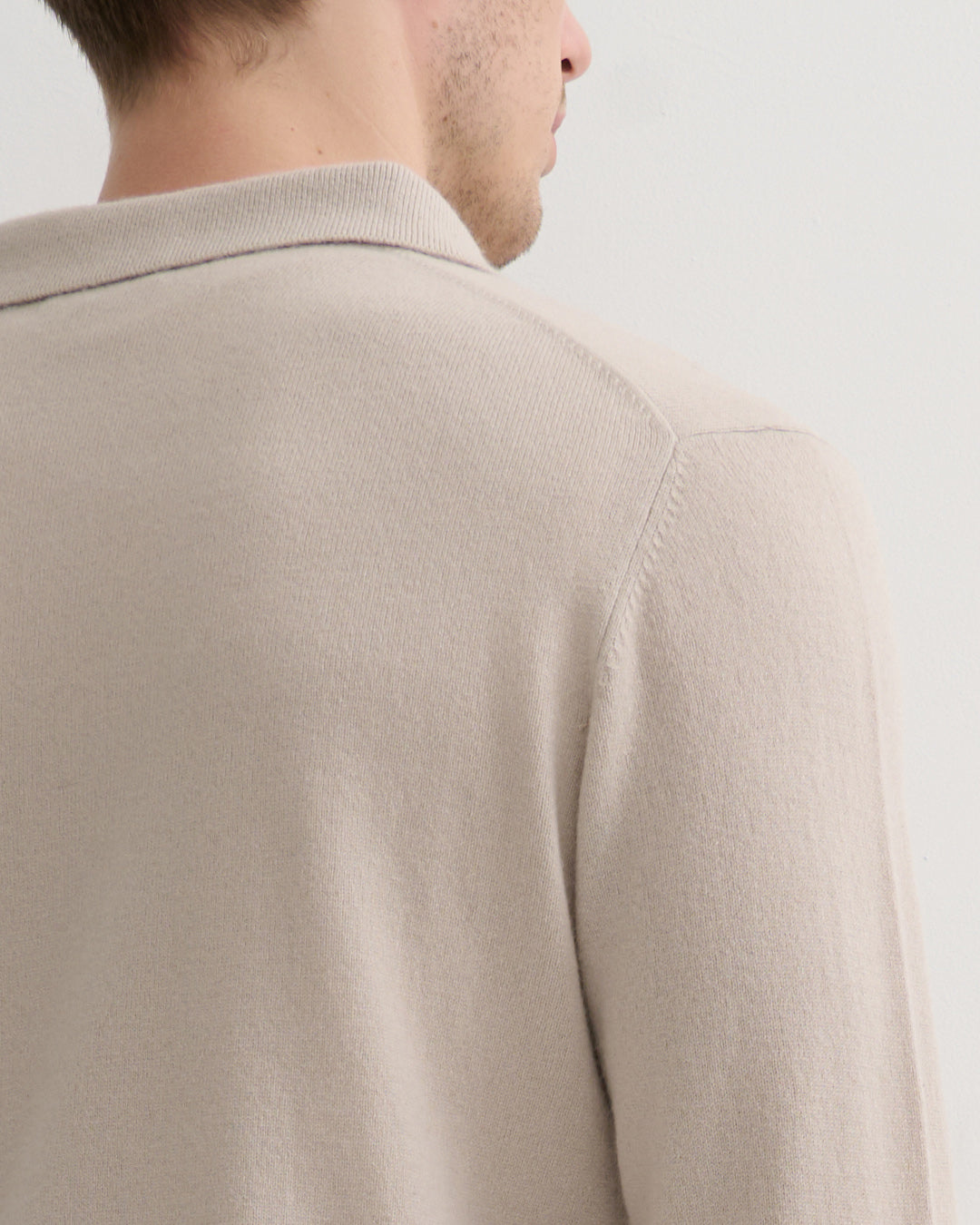 Model wearing Size L Men's Cashmere polo style Pullover in ceramic clay hue- Back shoulder detail 